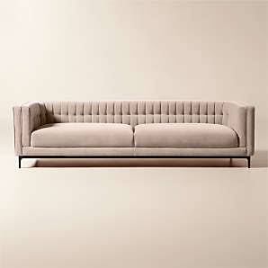 Beige velvet sofa with detailed vertical fluting along the back and arms
